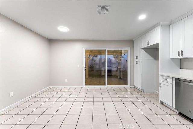 kitchen with light tile patterned floors, dishwasher, and white cabinets