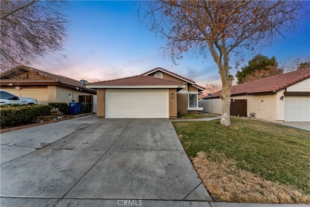 single story home with a garage and a yard