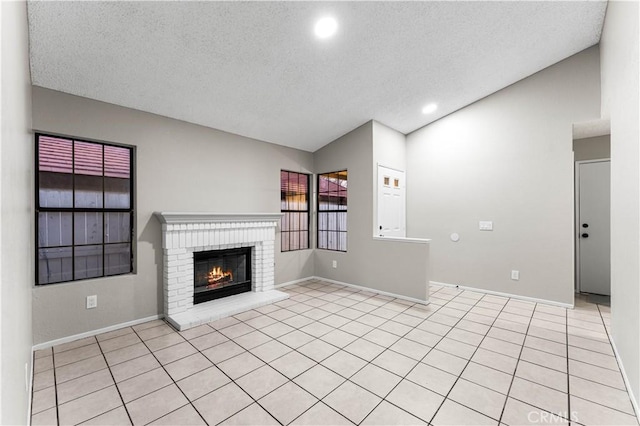 unfurnished living room featuring light tile patterned floors, a textured ceiling, vaulted ceiling, and a fireplace