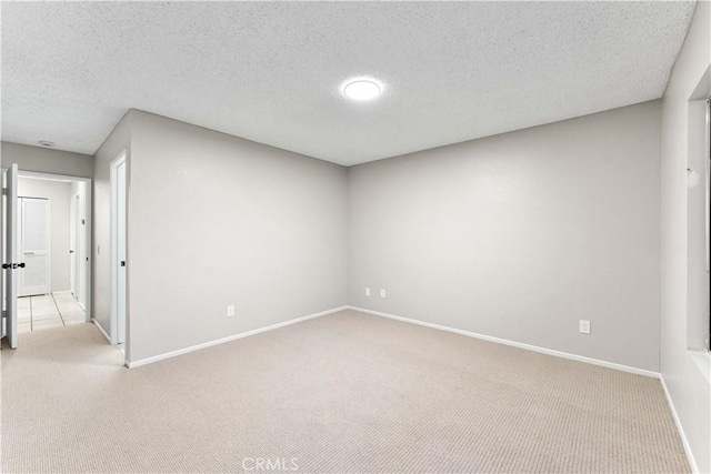 carpeted empty room with a textured ceiling