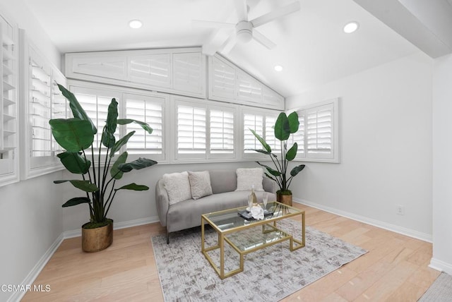 living room with light hardwood / wood-style floors, vaulted ceiling with beams, and ceiling fan