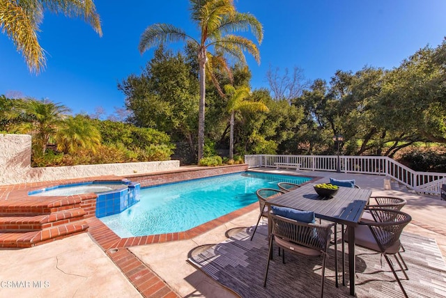 view of swimming pool with an in ground hot tub and a patio area