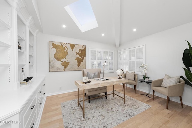 office featuring beam ceiling, light hardwood / wood-style flooring, and a skylight