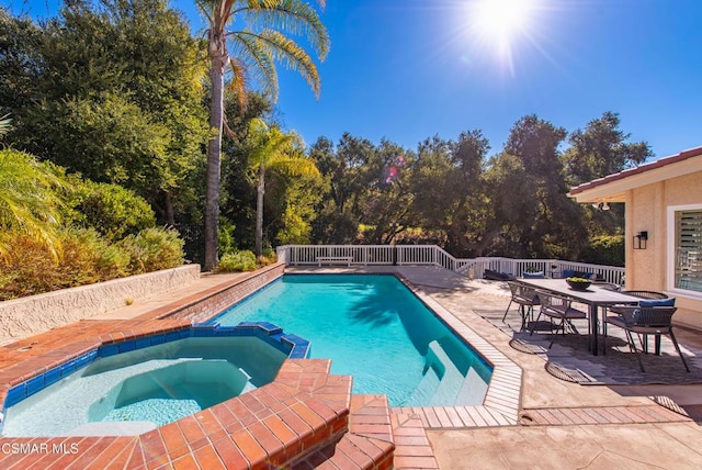 view of pool with an in ground hot tub and a patio area