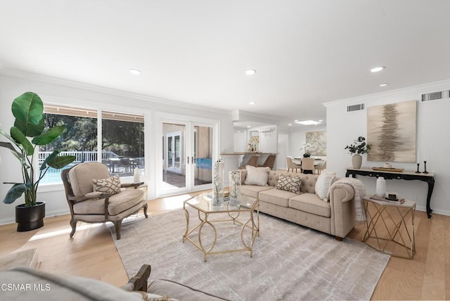 living room featuring light hardwood / wood-style floors and ornamental molding