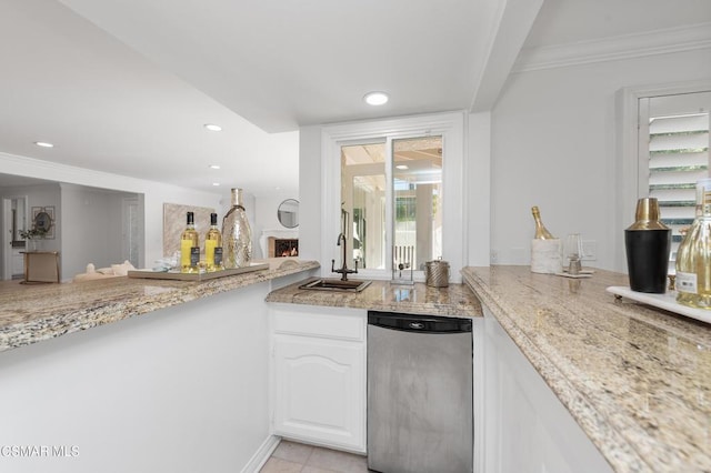 kitchen featuring sink, white cabinets, light stone countertops, and crown molding