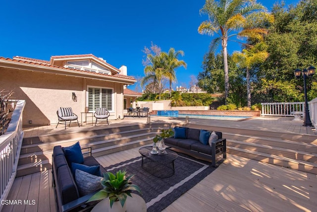 wooden terrace featuring an outdoor hangout area