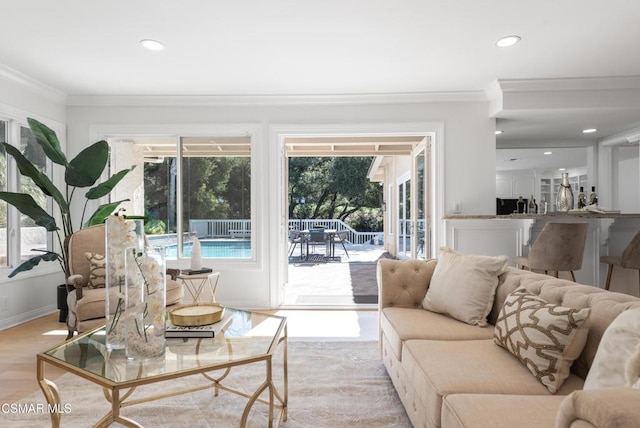 living room with light hardwood / wood-style flooring and ornamental molding