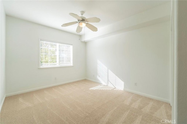 carpeted spare room featuring ceiling fan