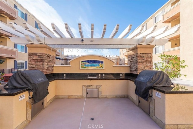 view of patio with a grill and an outdoor kitchen