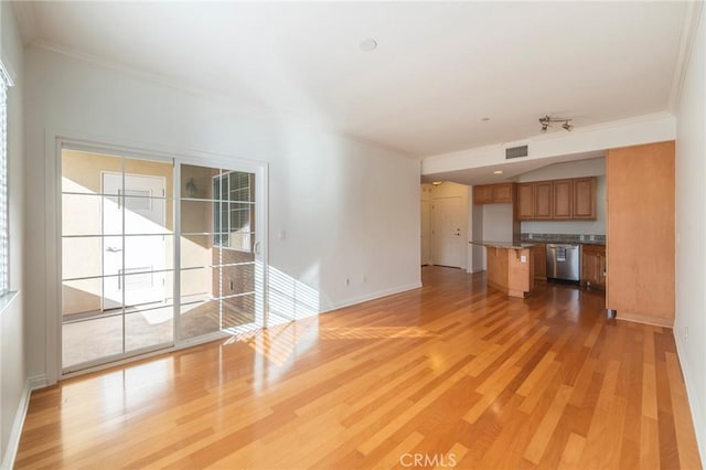 unfurnished living room with crown molding and light hardwood / wood-style flooring