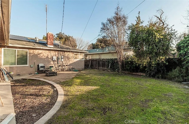 view of yard featuring a fire pit and a patio