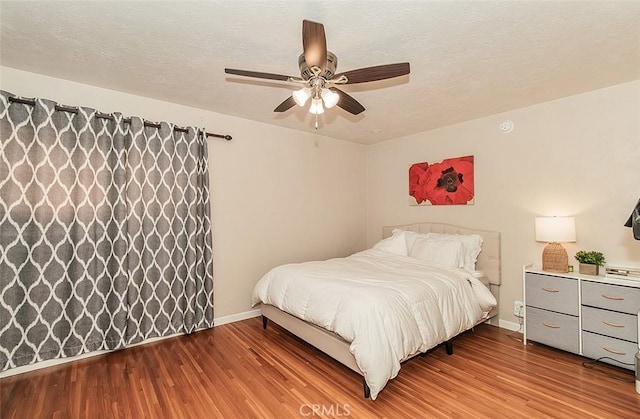 bedroom with ceiling fan and wood-type flooring