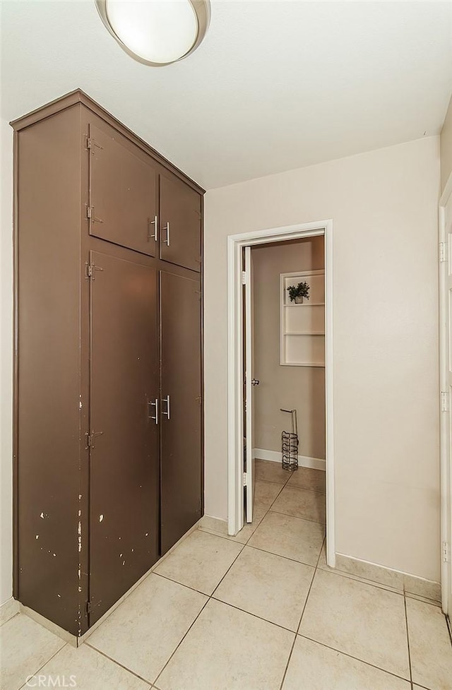 interior space with a closet and light tile patterned flooring