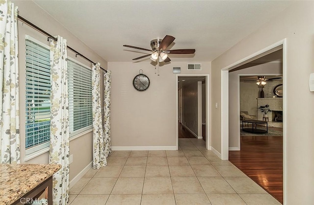 hall with light tile patterned floors