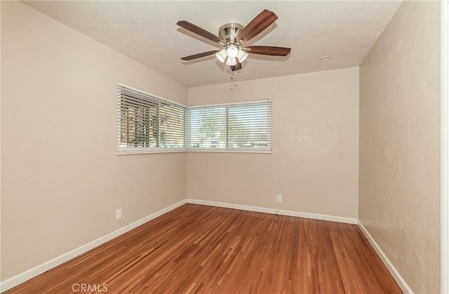 empty room featuring hardwood / wood-style flooring and ceiling fan