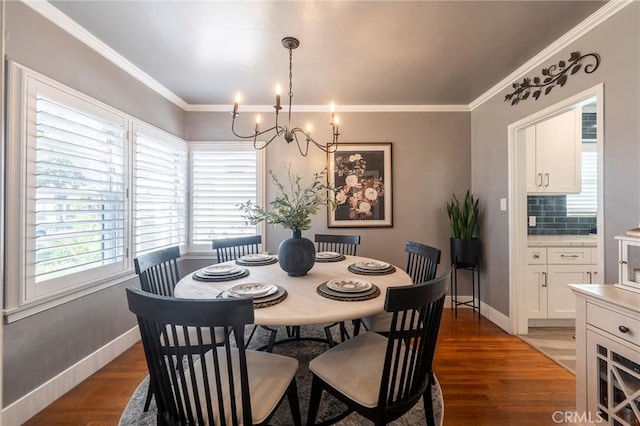 dining room featuring ornamental molding, dark hardwood / wood-style floors, and a notable chandelier