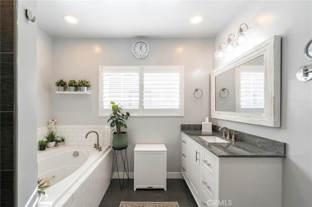 bathroom featuring vanity, tile patterned floors, and tiled tub