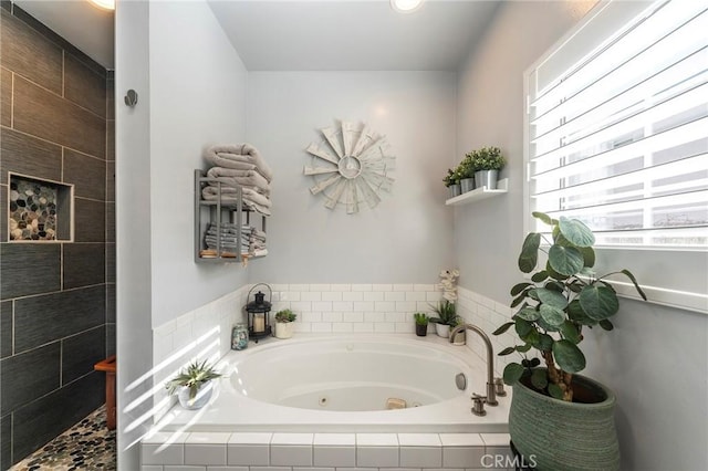 bathroom featuring a relaxing tiled tub