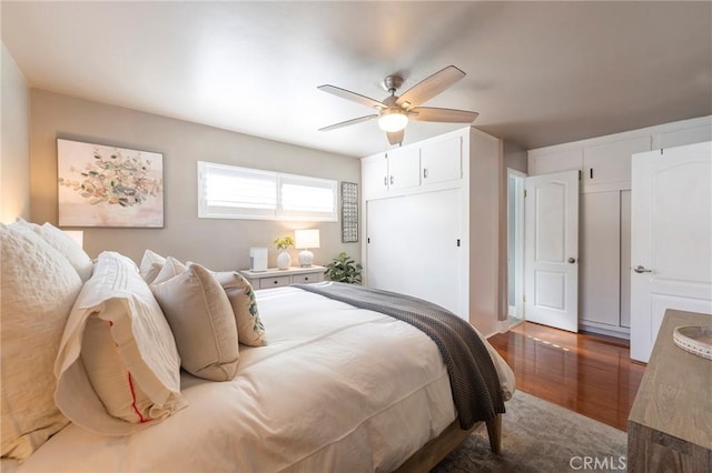 bedroom featuring ceiling fan and dark wood-type flooring