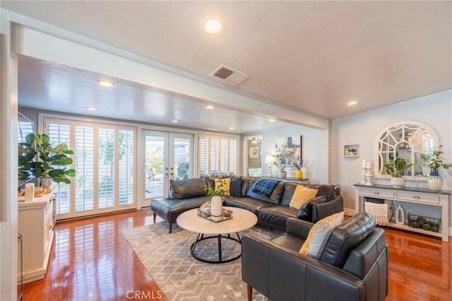 living room featuring french doors and hardwood / wood-style flooring