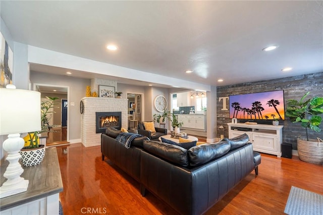 living room with dark hardwood / wood-style floors and a fireplace