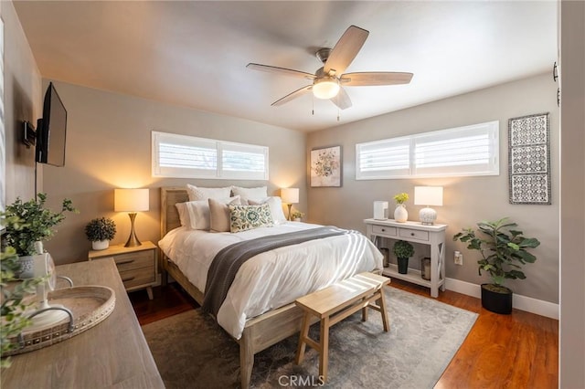 bedroom with ceiling fan and dark hardwood / wood-style flooring