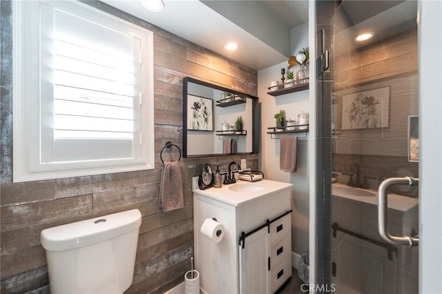 bathroom with toilet, vanity, and walk in shower