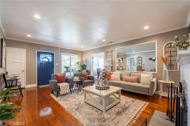 living room with hardwood / wood-style flooring and ornamental molding