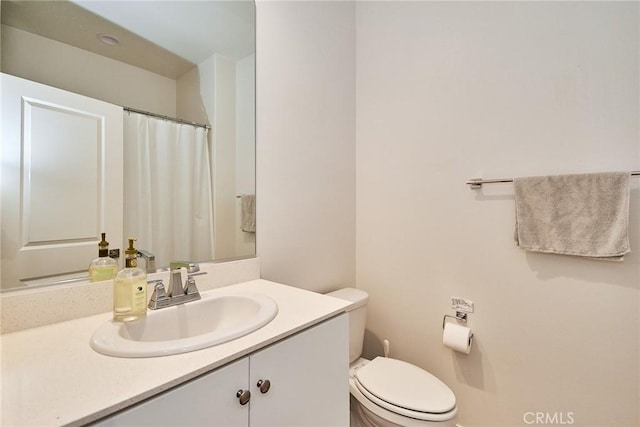 bathroom with toilet and vanity