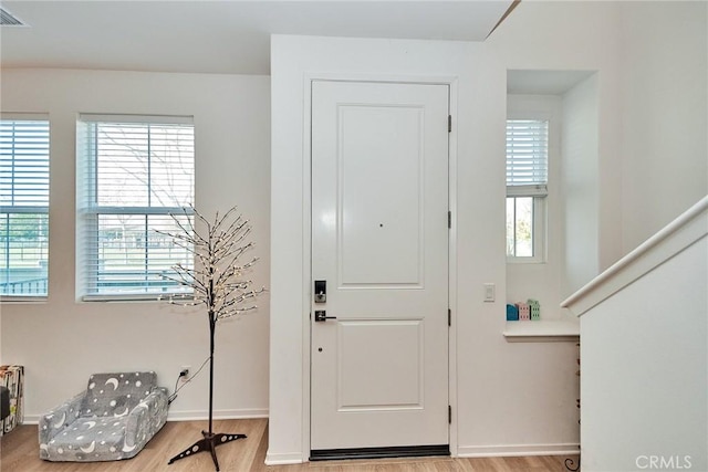 foyer entrance with light hardwood / wood-style floors