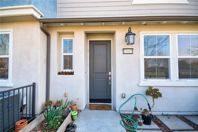 property entrance featuring central AC unit