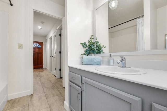 bathroom featuring tile patterned flooring, vanity, and shower / bath combination with curtain