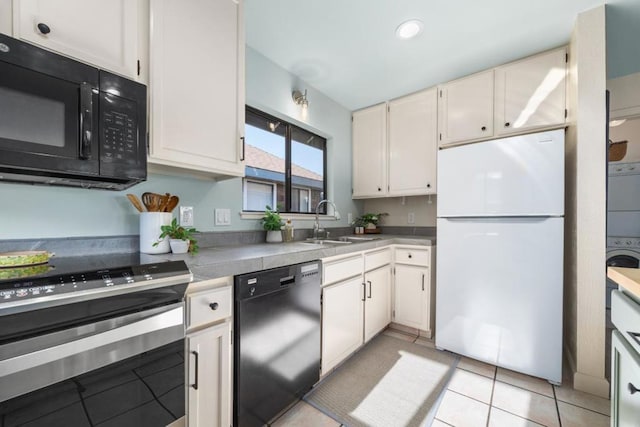 kitchen featuring sink, black appliances, white cabinets, and light tile patterned flooring