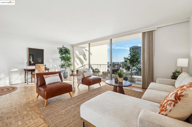 living room with light parquet floors and a wall of windows