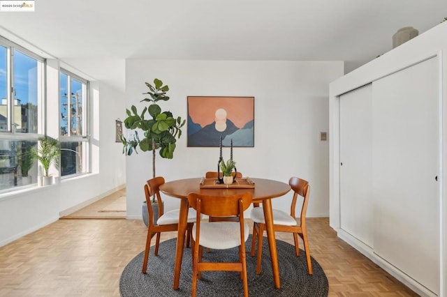 dining space with light parquet floors