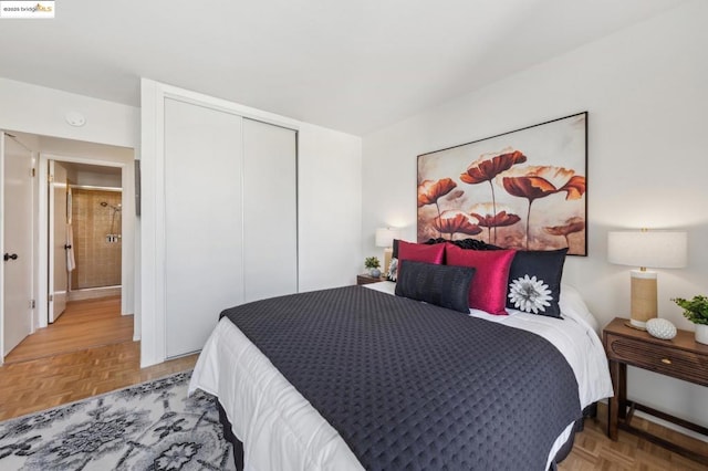 bedroom featuring parquet flooring and a closet