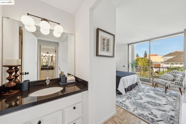 bathroom with vanity, parquet floors, and floor to ceiling windows