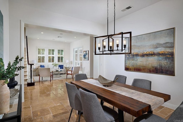 dining area with a notable chandelier, stone tile flooring, visible vents, and recessed lighting