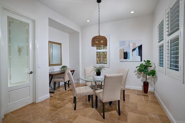 dining room featuring stone tile floors, baseboards, and recessed lighting