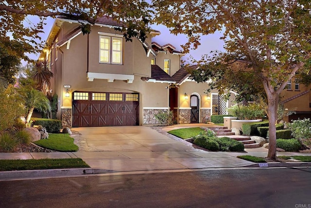 view of front of property with an attached garage, stone siding, concrete driveway, a tiled roof, and stucco siding