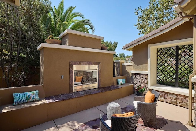 view of patio / terrace with an outdoor living space with a fireplace