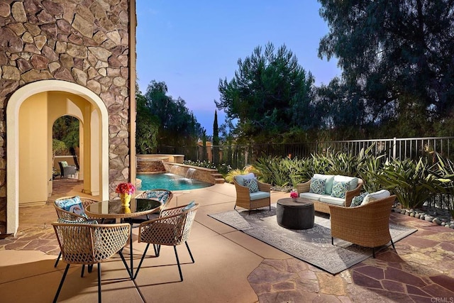 view of patio / terrace with a fenced backyard, an outdoor living space, and a fenced in pool