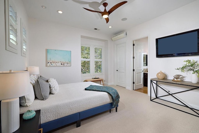 bedroom with recessed lighting, visible vents, ensuite bathroom, carpet flooring, and a wall mounted air conditioner