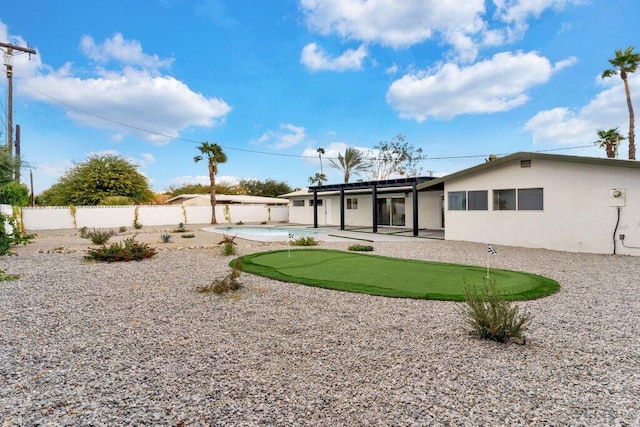 back of house with a fenced in pool and a patio area