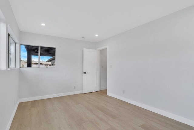 empty room with light hardwood / wood-style floors