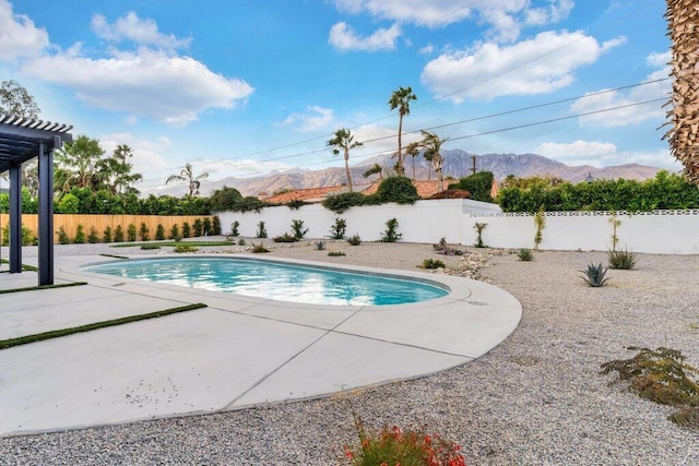 view of pool featuring a mountain view and a patio area