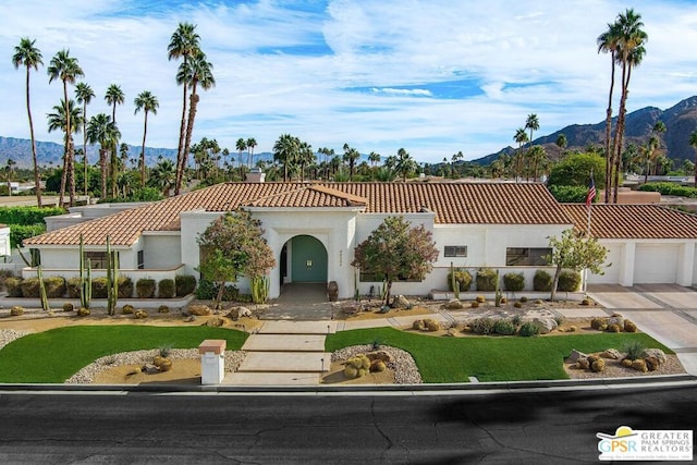 view of front of house with a mountain view and a garage