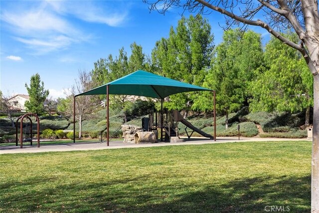 view of community featuring a playground and a lawn