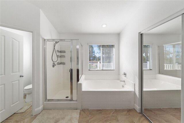 bathroom with tile patterned flooring, toilet, and shower with separate bathtub